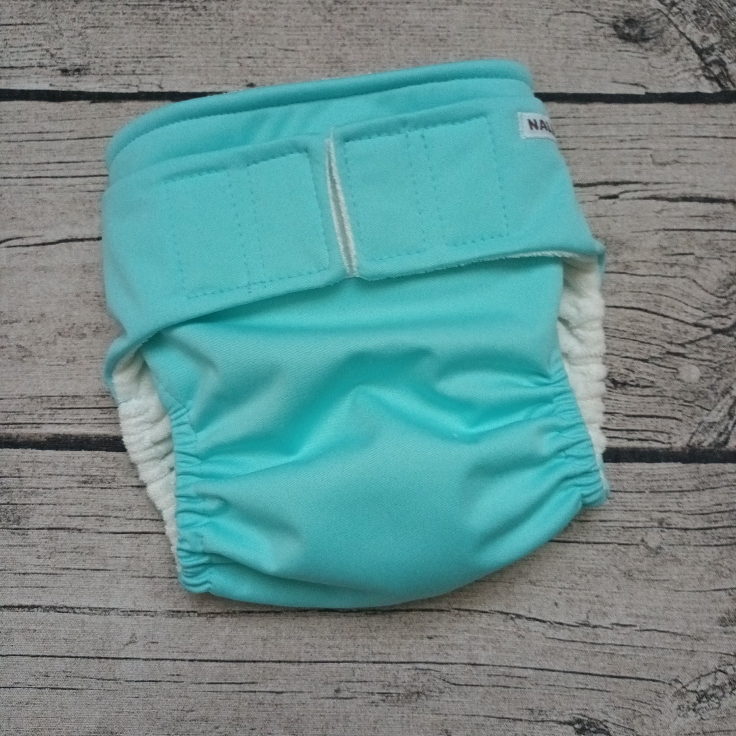 Nalle: Tasku-Nalle - Vaalea turkoosi TILAUSTUOTE